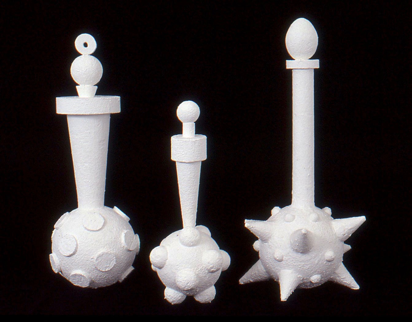 Three Muses — three white ceramic vessel forms