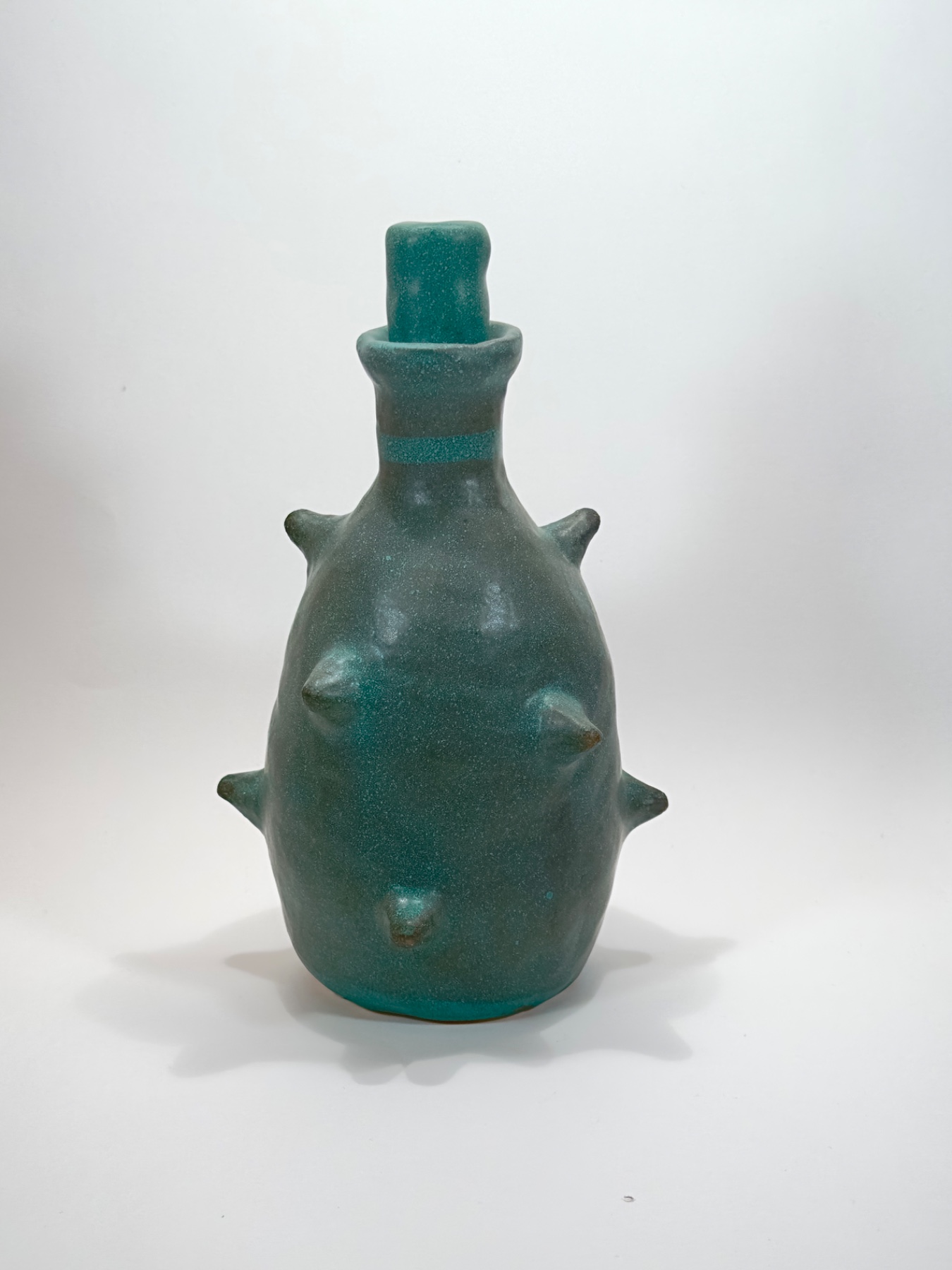Green stoppered vessel with applied spikes