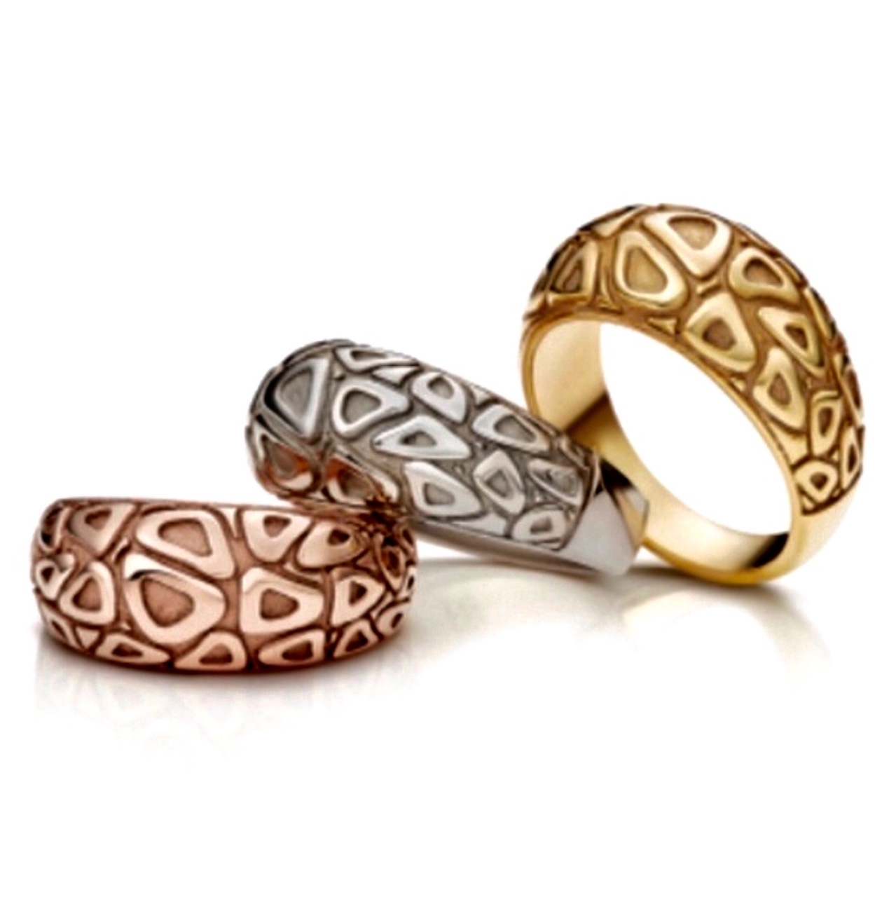 Three rounded rings in rose gold, white gold and yellow gold