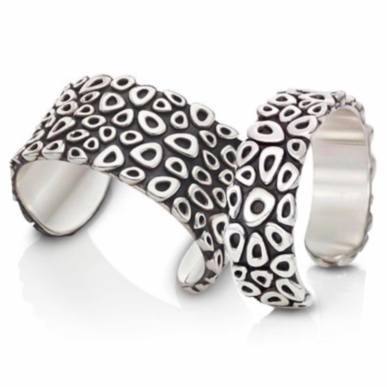 Two silver cuffs with cellular pattern